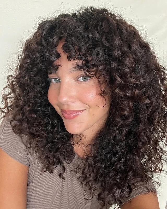 6. Chocolate Curly Shag with Bangs - Curly Hairstyles