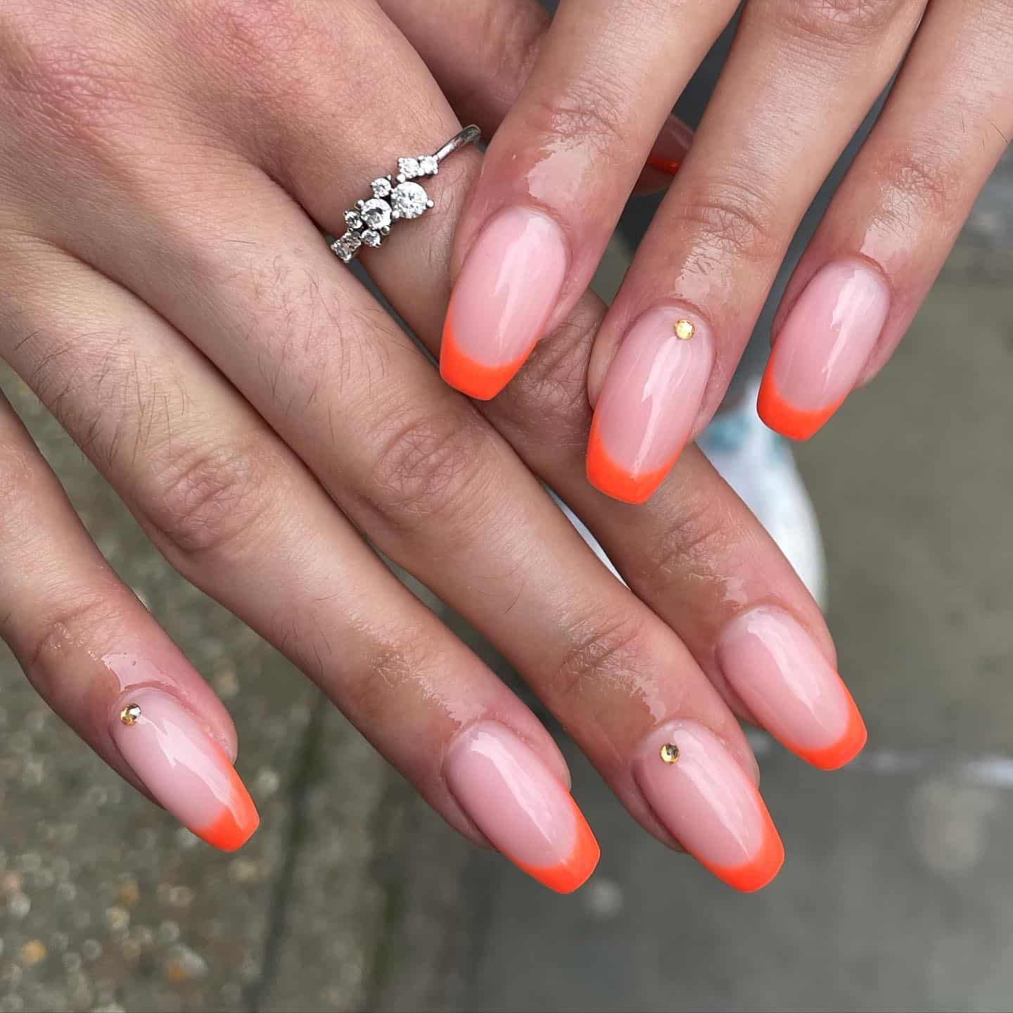 2. Neon Orange French with Golden Accents - neon orange nail ideas