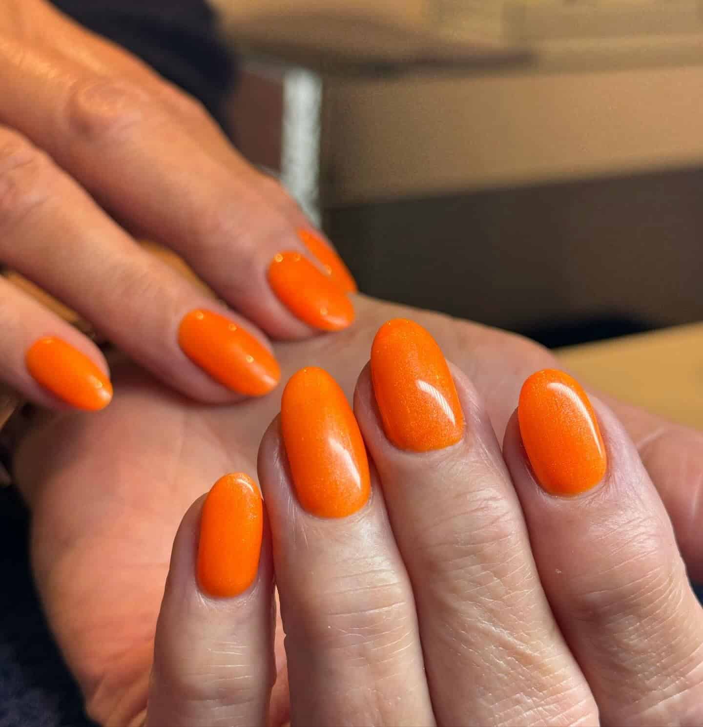 7. Soft Tangerine Shine - neon orange nail ideas