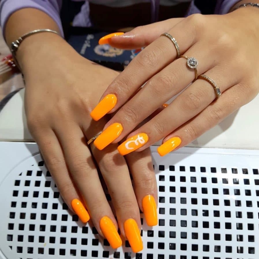 9. Vibrant Long Neon Statement - neon orange nail ideas