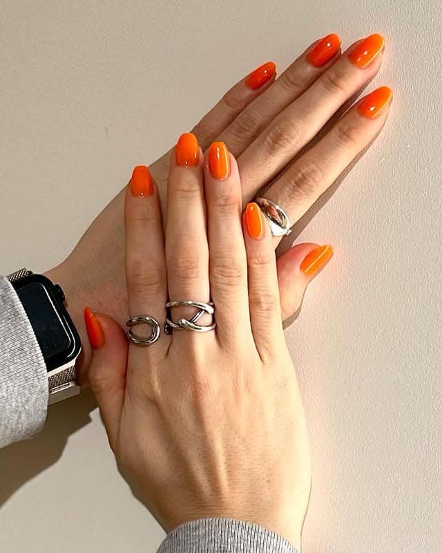 21. Glossy Tangerine Shine - neon orange nail ideas