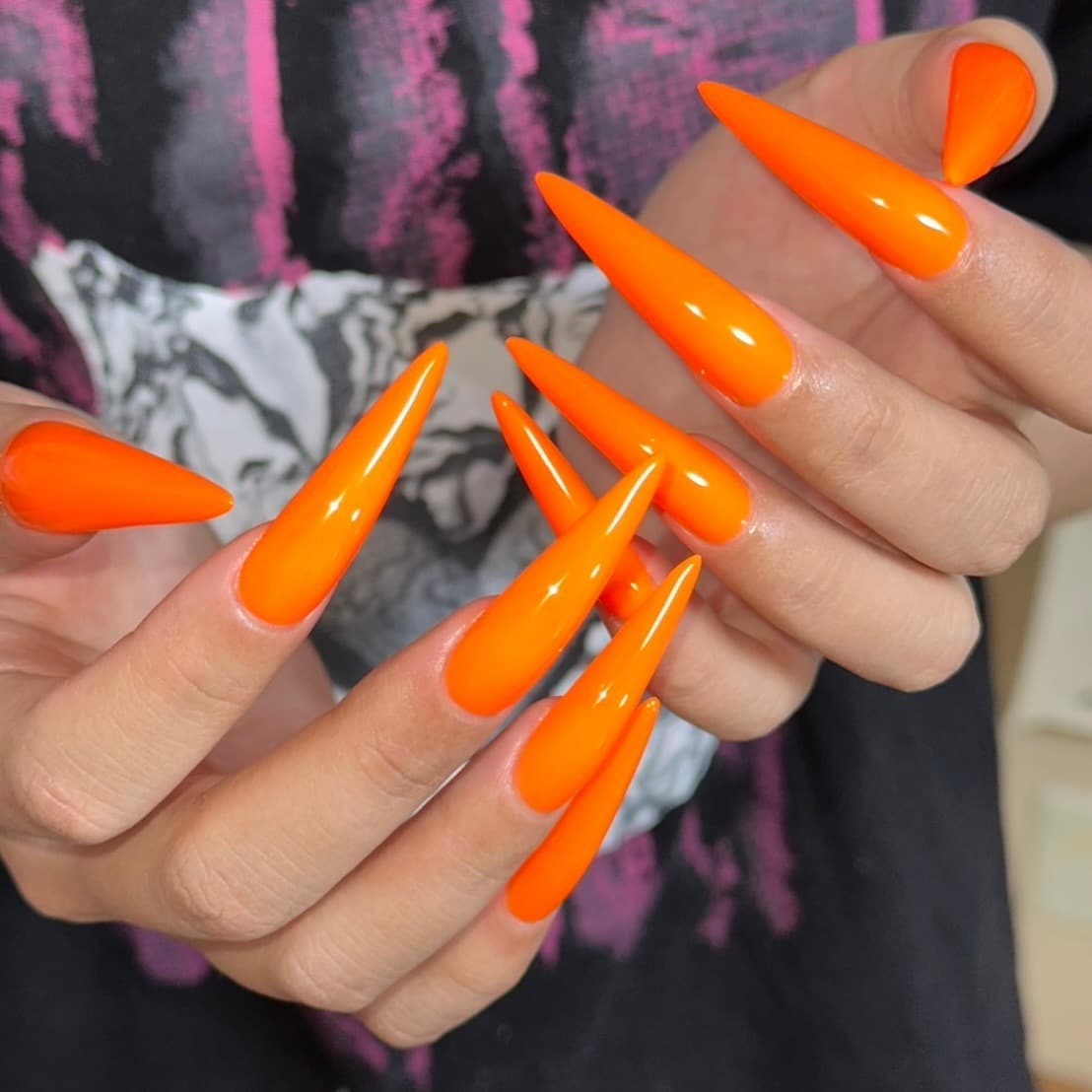 22. Neon Stiletto Power Nails - neon orange nail ideas