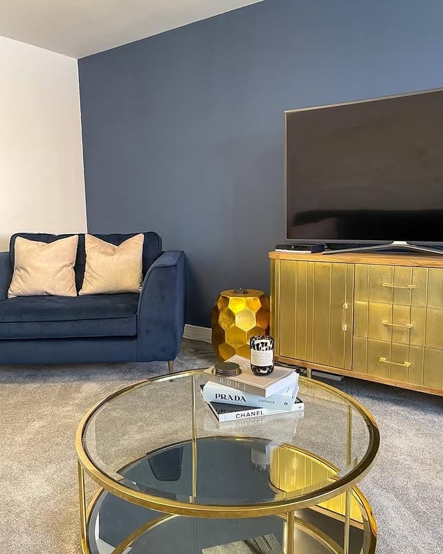 11. Sleek Navy and Gold Minimalism - blue and gold living room ideas