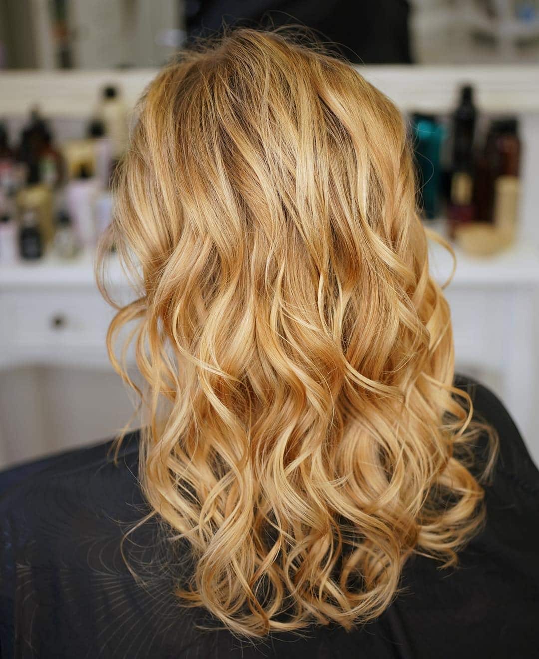 21. Golden Honey Curls with Radiant Depth - Honey Blonde Hair Color