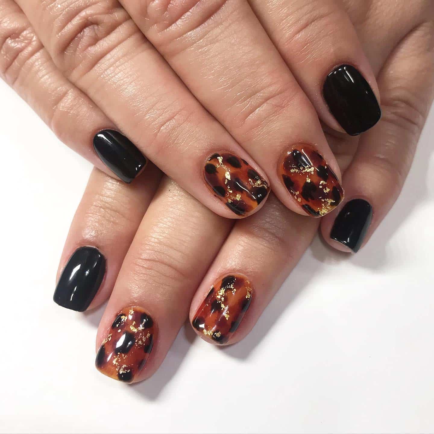 8. Tortoiseshell Chic – Black and Amber Short Nails - new years eve nail ideas
