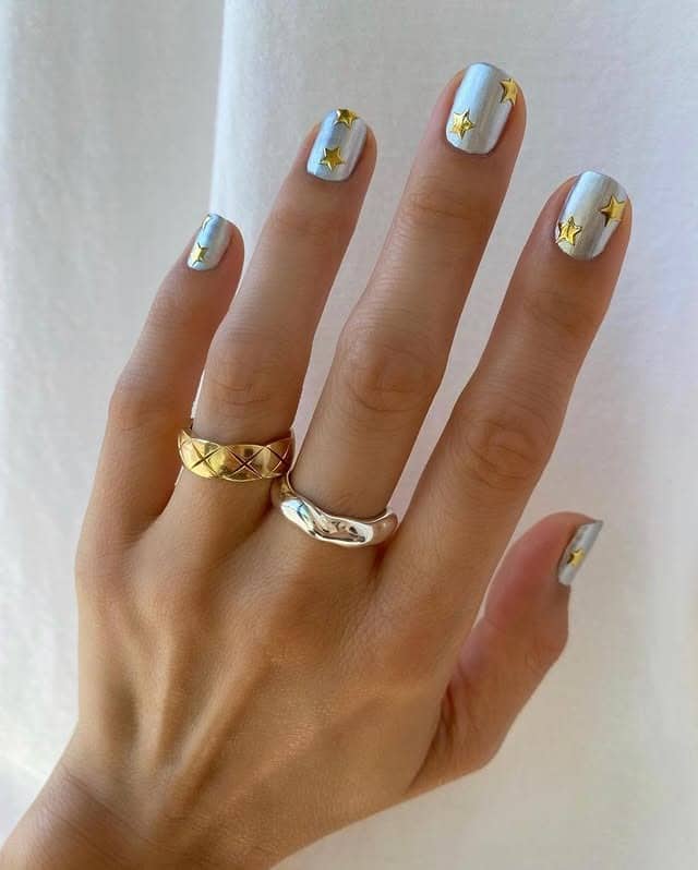 10. Celestial Stars – Sky Blue Nails with Gold Stars - new years eve nail ideas
