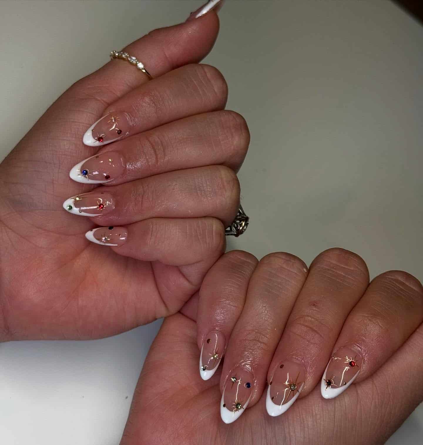15. Crystal Elegance – White French Tips with Gem Accents - new years eve nail ideas