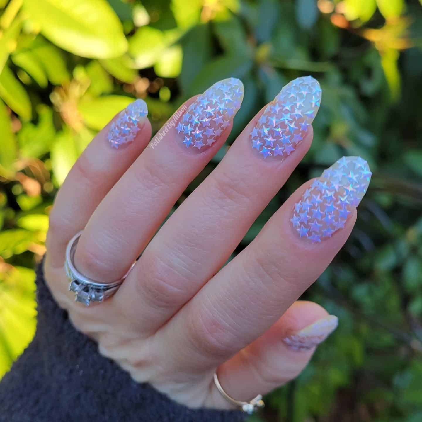 17. Starry Frost – Iridescent Blue Star Nails - new years eve nail ideas
