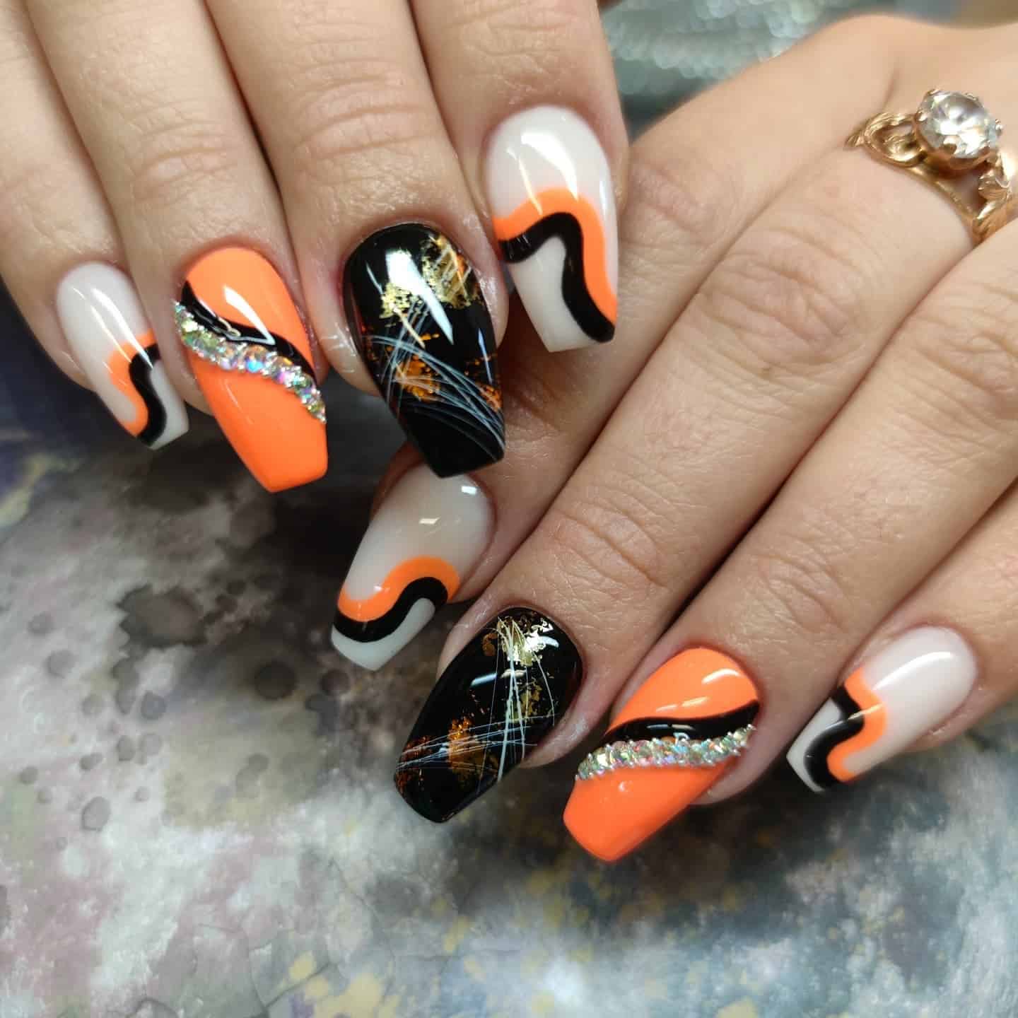 6. Cosmic Ember Waves - orange and black nail ideas