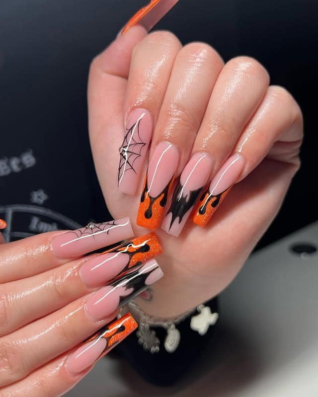 7. Spooky Drip Glam - orange and black nail ideas