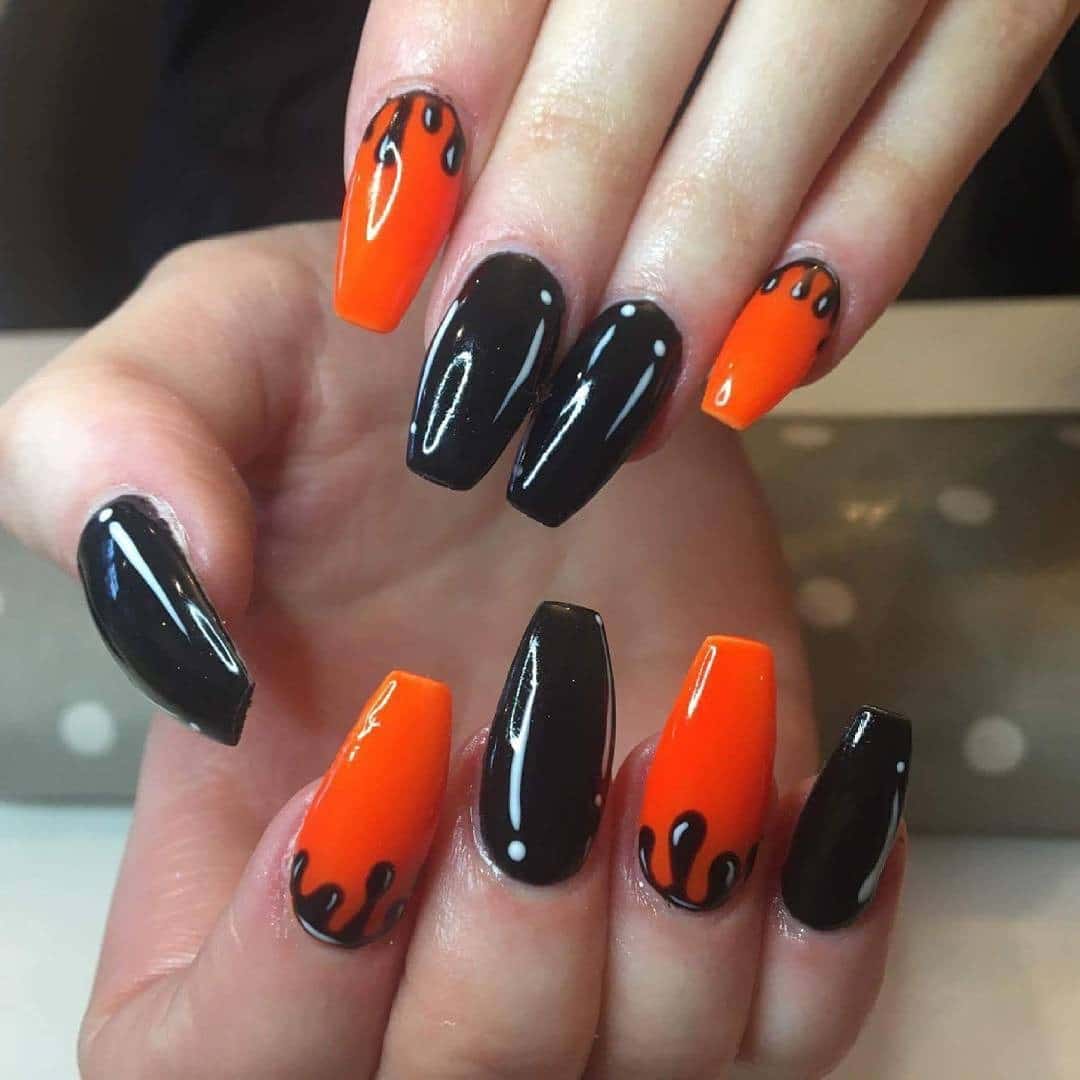 8. Midnight Flame Fusion - orange and black nail ideas