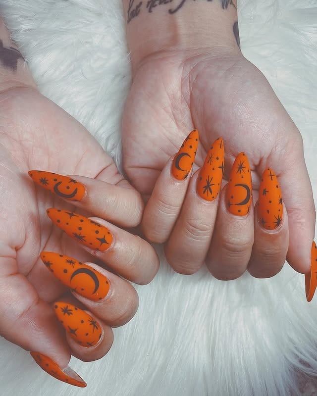 10. Celestial Pumpkin Magic - orange and black nail ideas