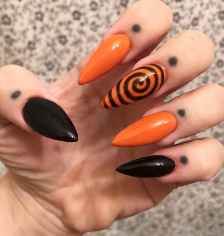 14. Spiral Enchantment - orange and black nail ideas