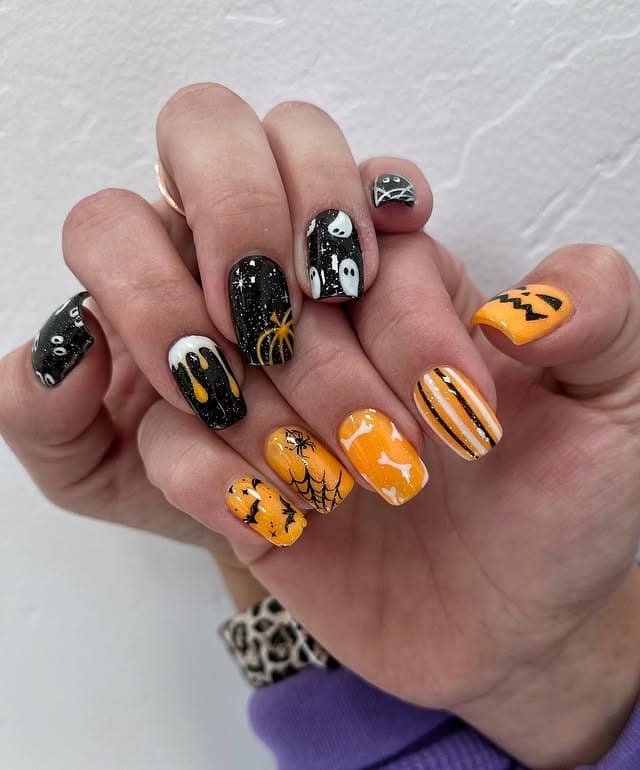 15. Haunted Patchwork Mix - orange and black nail ideas
