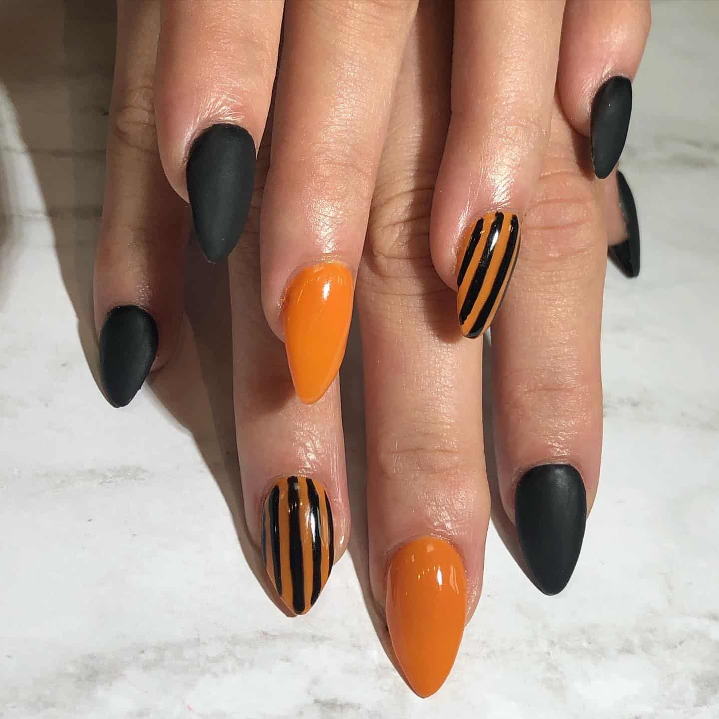 17. Striped Ember Chic - orange and black nail ideas