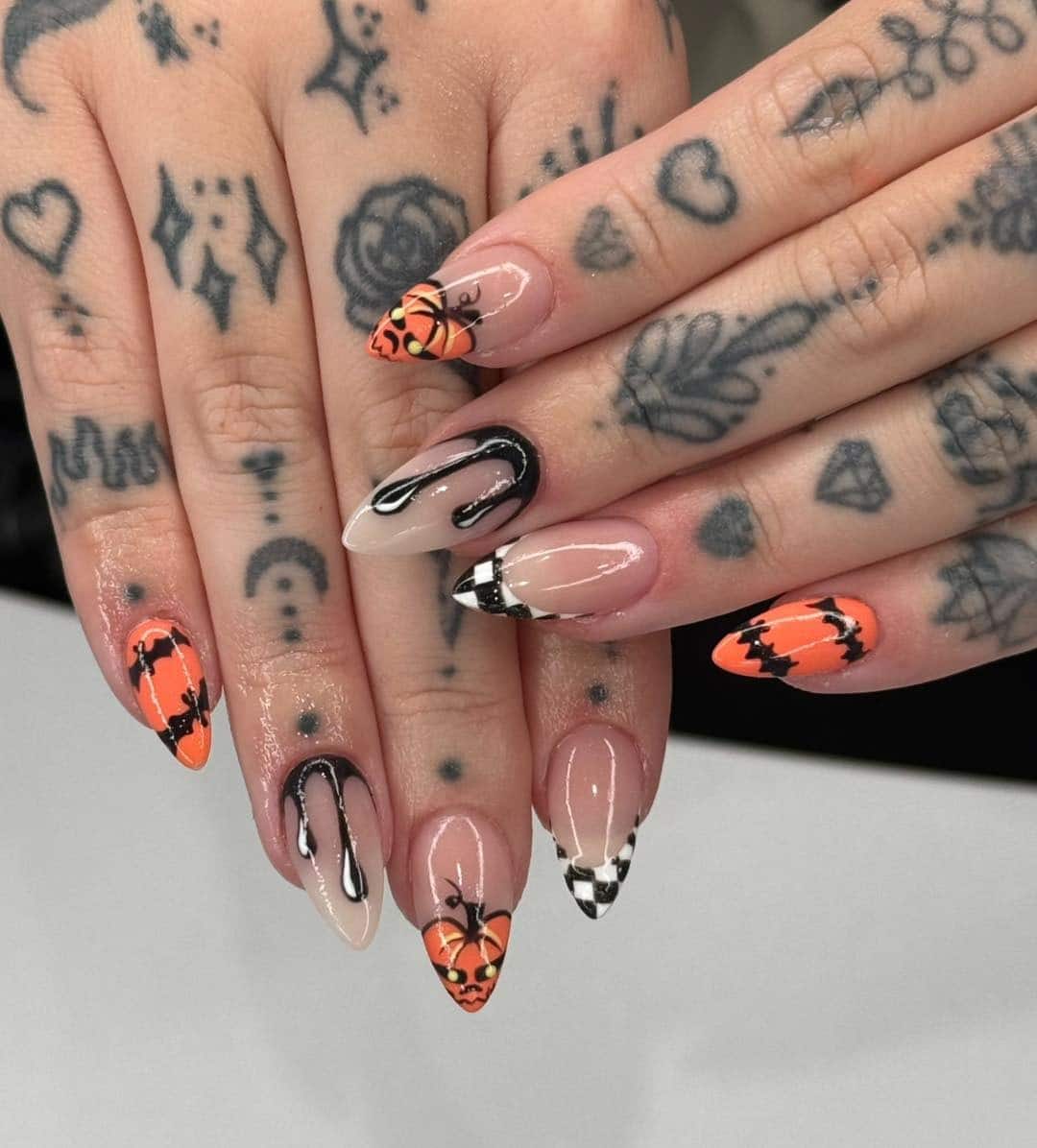 20. Checkerboard Pumpkin Mix - orange and black nail ideas