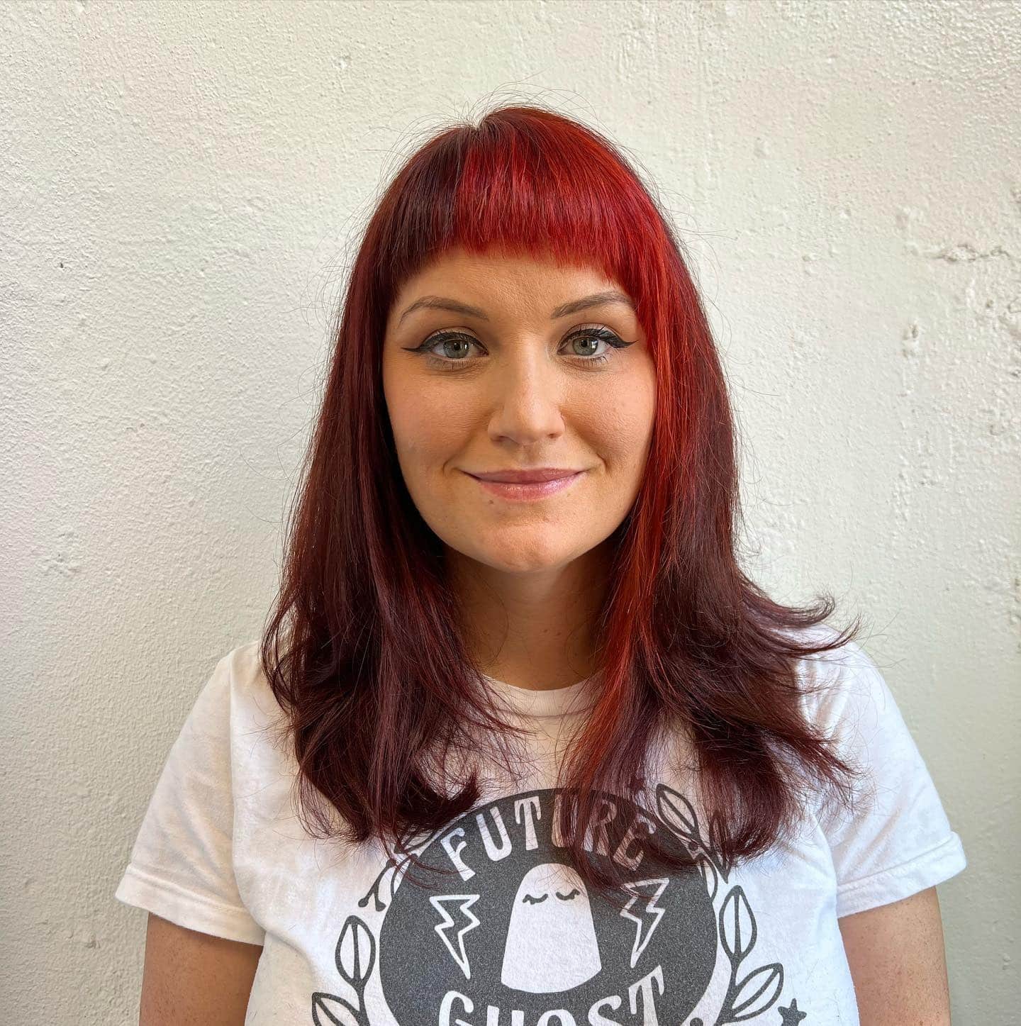 17. Crimson Layered Cut with Sculpted Micro Bangs - Asymmetrical Bangs Hairstyles