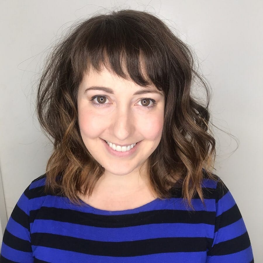 18. Soft Brunette Waves with Feathered Micro Fringe - Asymmetrical Bangs Hairstyles