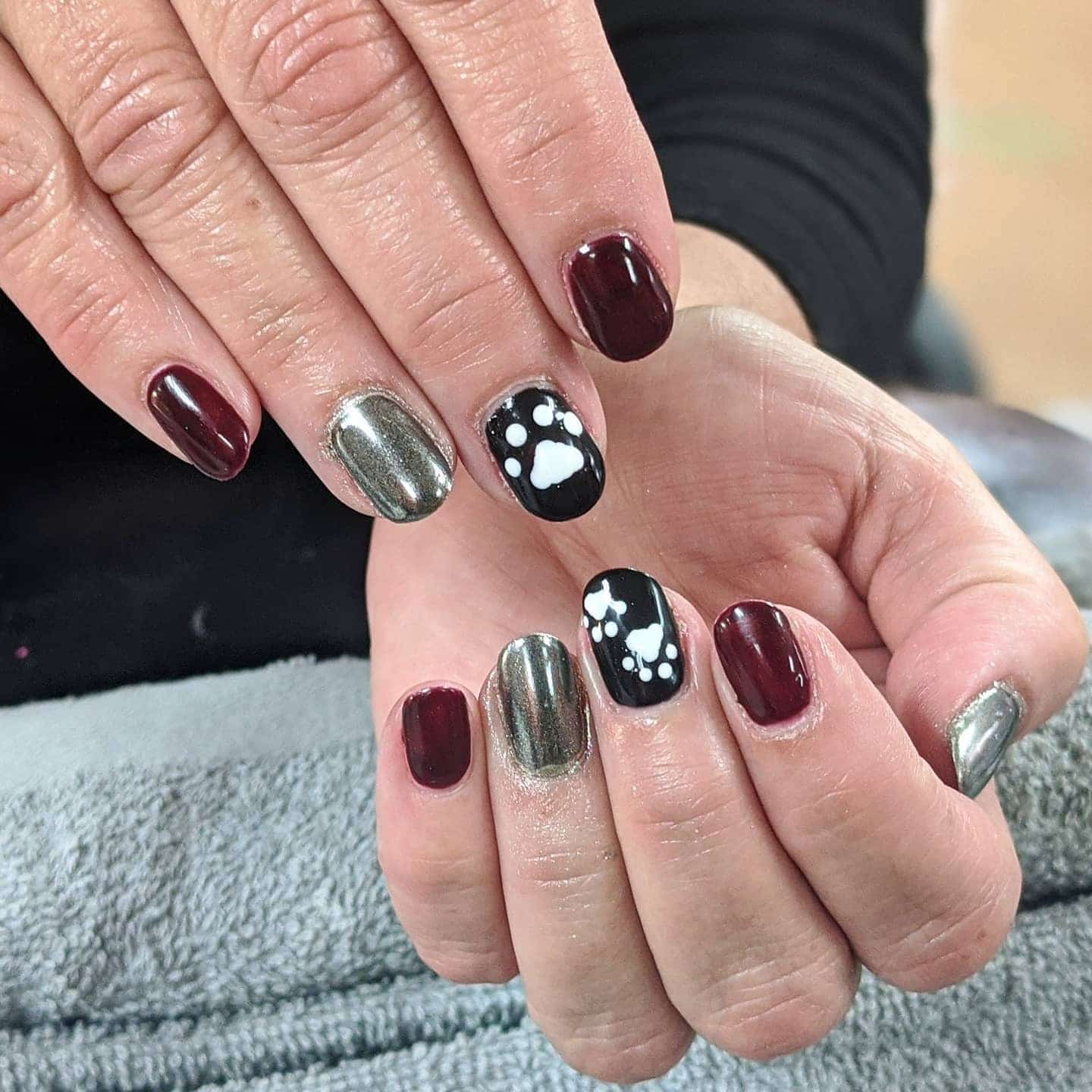 1. Metallic Burgundy Paw Print Elegance - paw print nail ideas