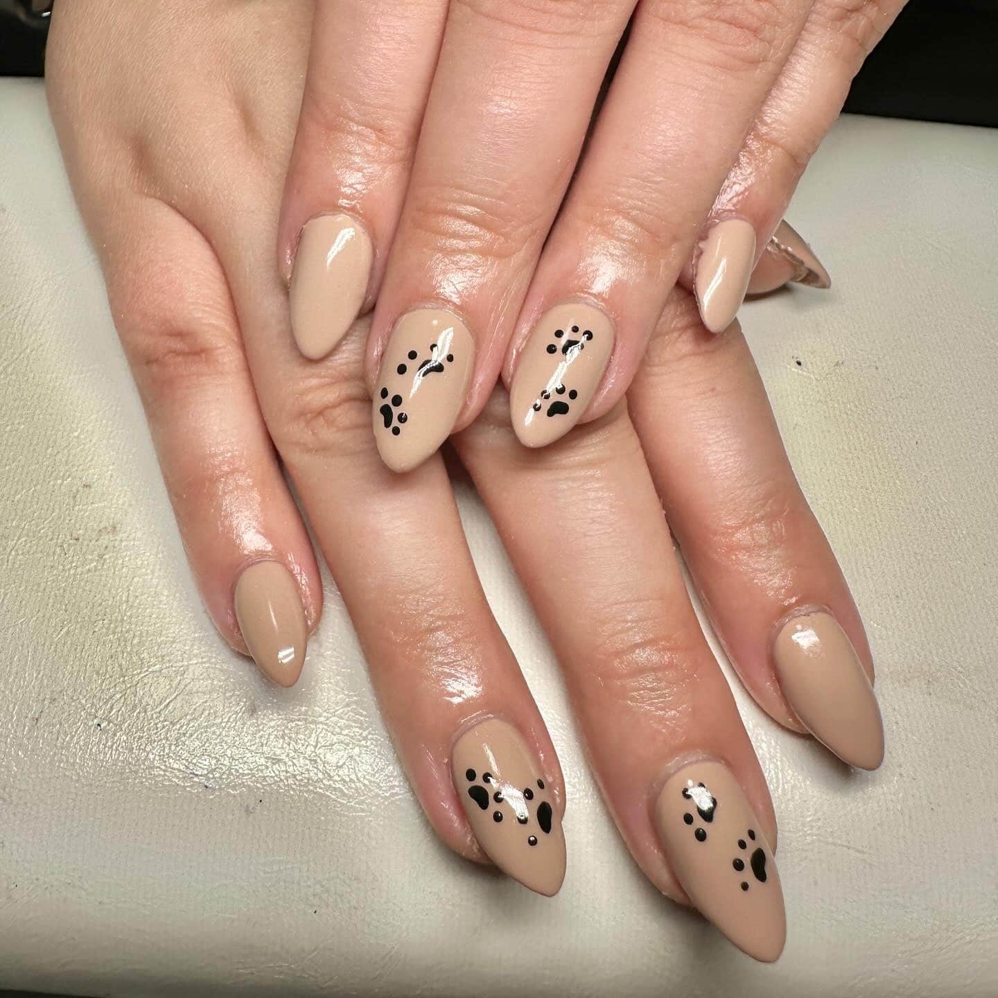 15. Neutral Elegance with Paw Trails - paw print nail ideas