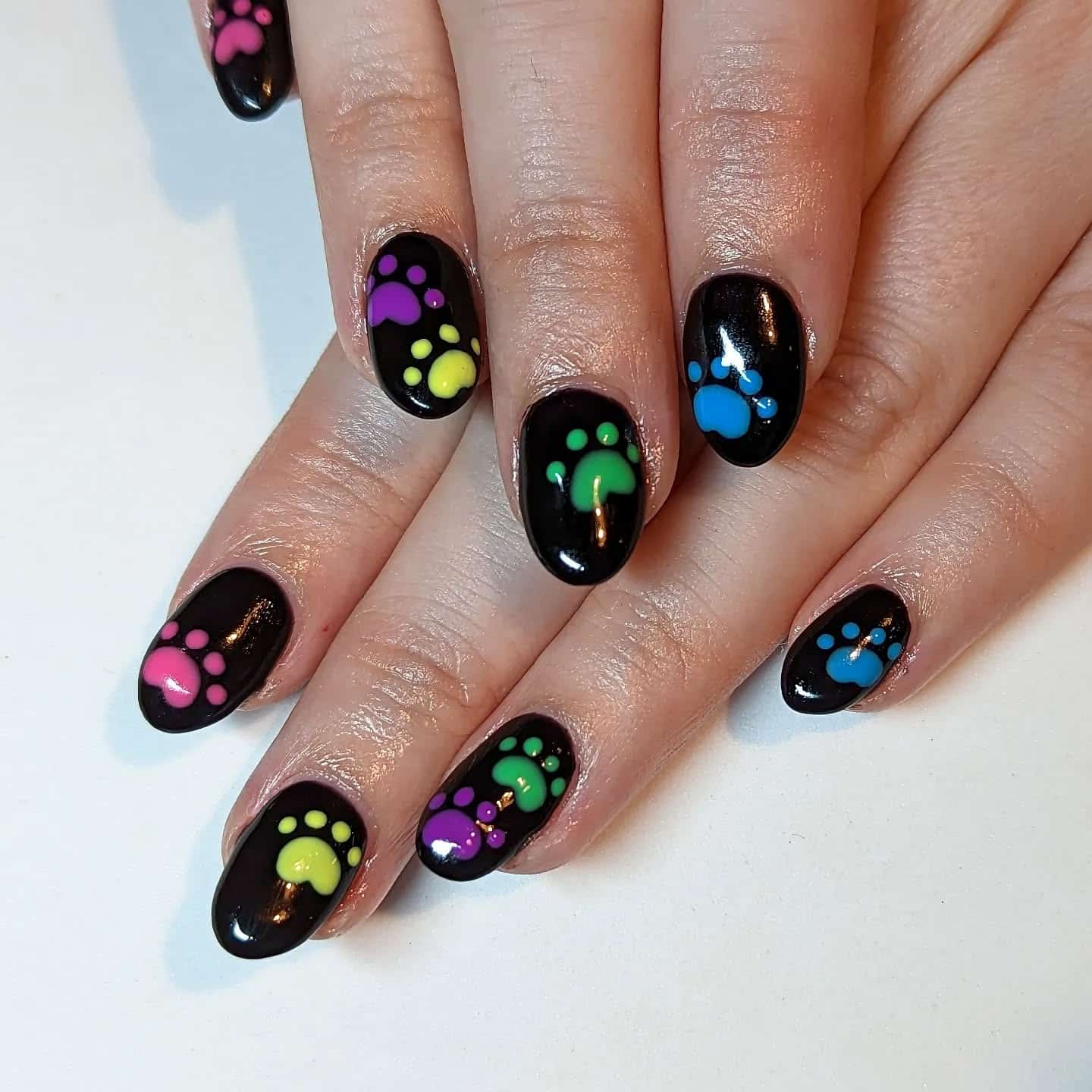 18. Rainbow Paw Shine on Black Gel - paw print nail ideas