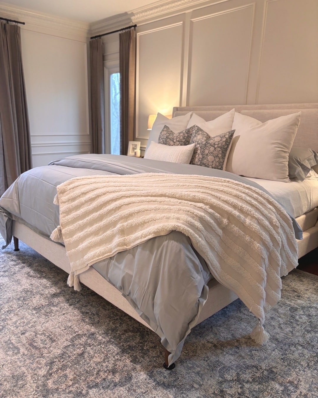 2. Soft Luxe Layers in Pale Grey and Cream - blank wall bedroom ideas