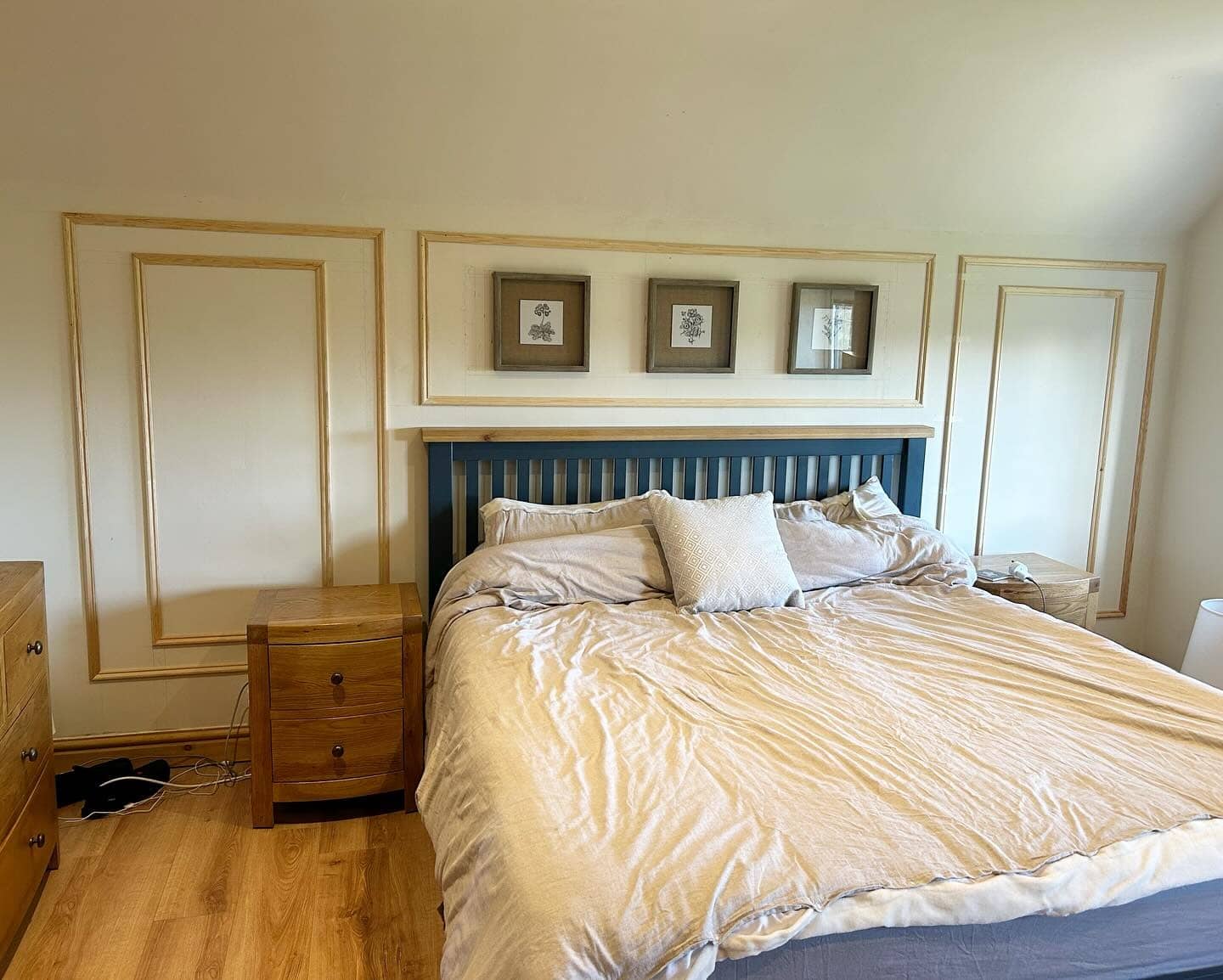 18. Framed Symmetry with Wood Accents - blank wall bedroom ideas