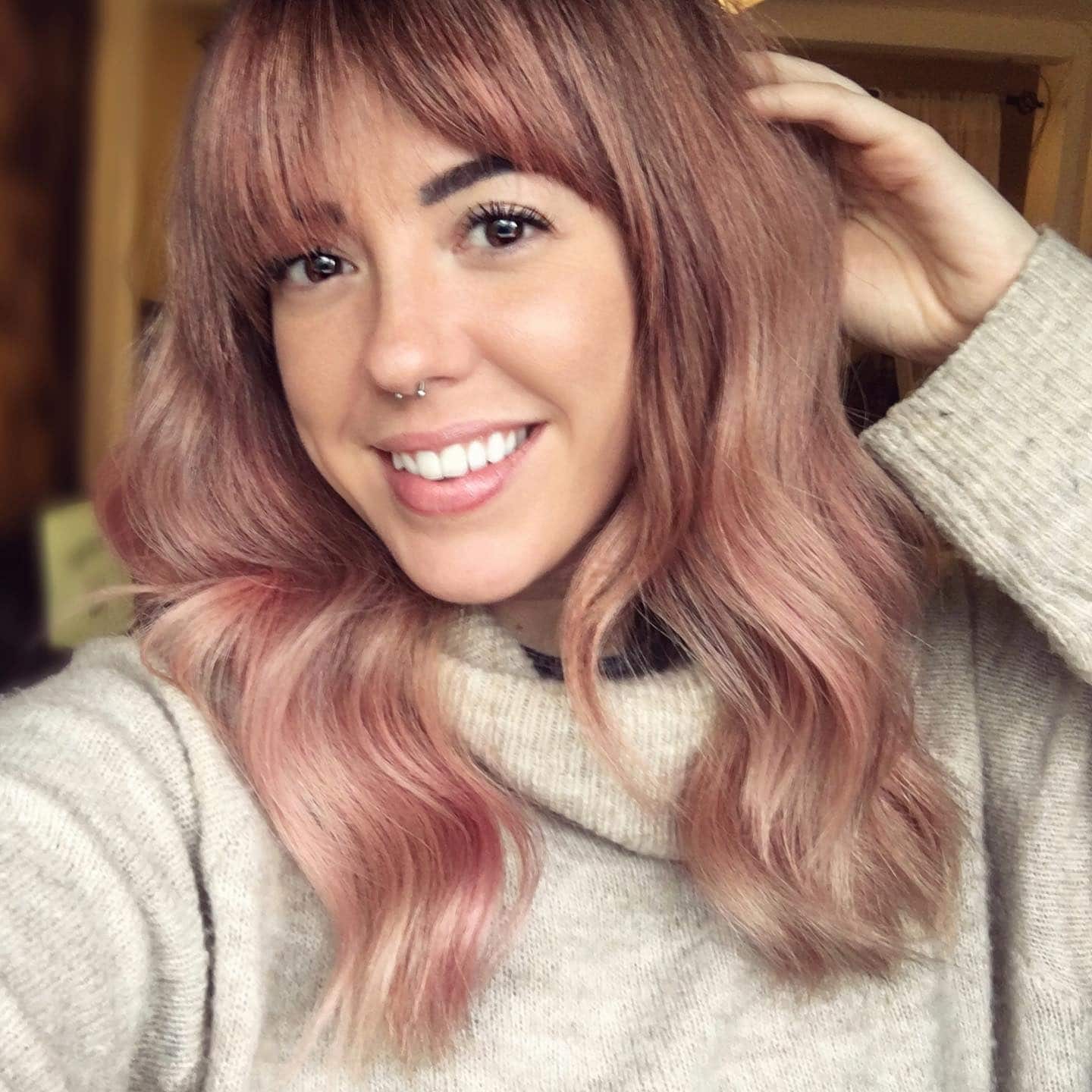 10. Warm Rose Gold with Curtain Bangs - Rose Gold Hair Color