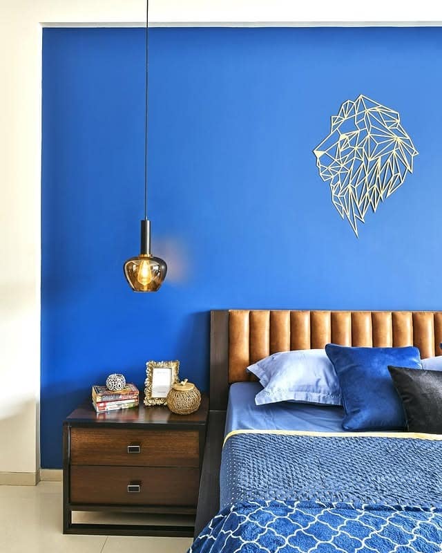 4. Royal Blue Contrast with Modern Warmth - blue wall bedroom ideas