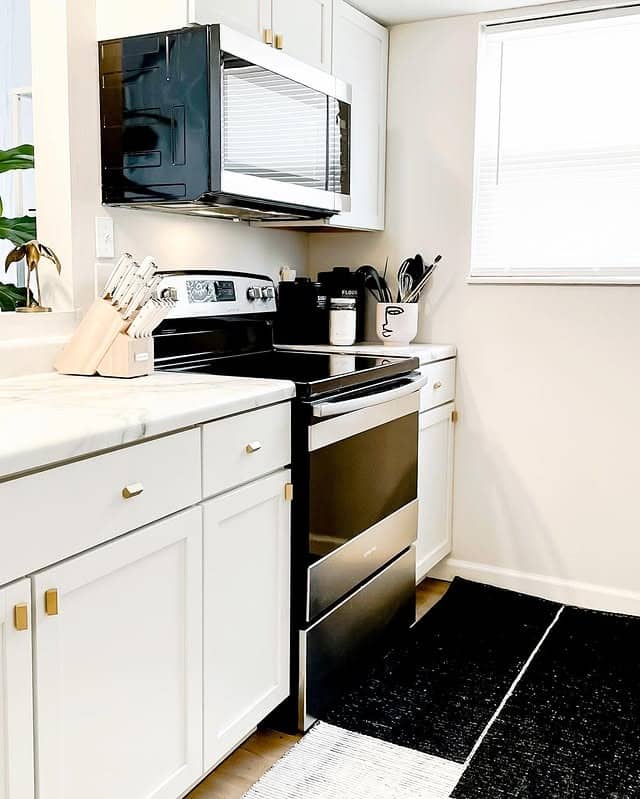 10. Clean-Lined White Kitchen with Subtle Contrast - small white kitchen ideas