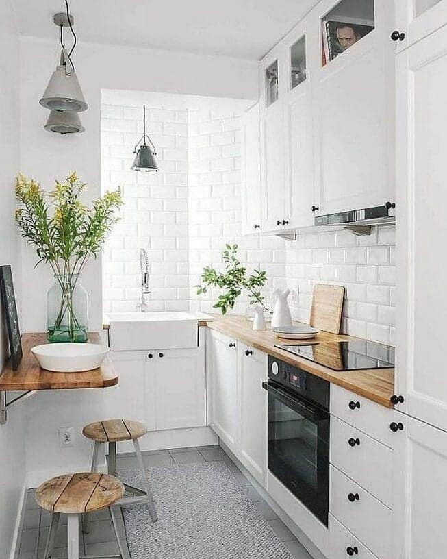 22. Scandinavian White Kitchen with Warm Wood Countertops - small white kitchen ideas