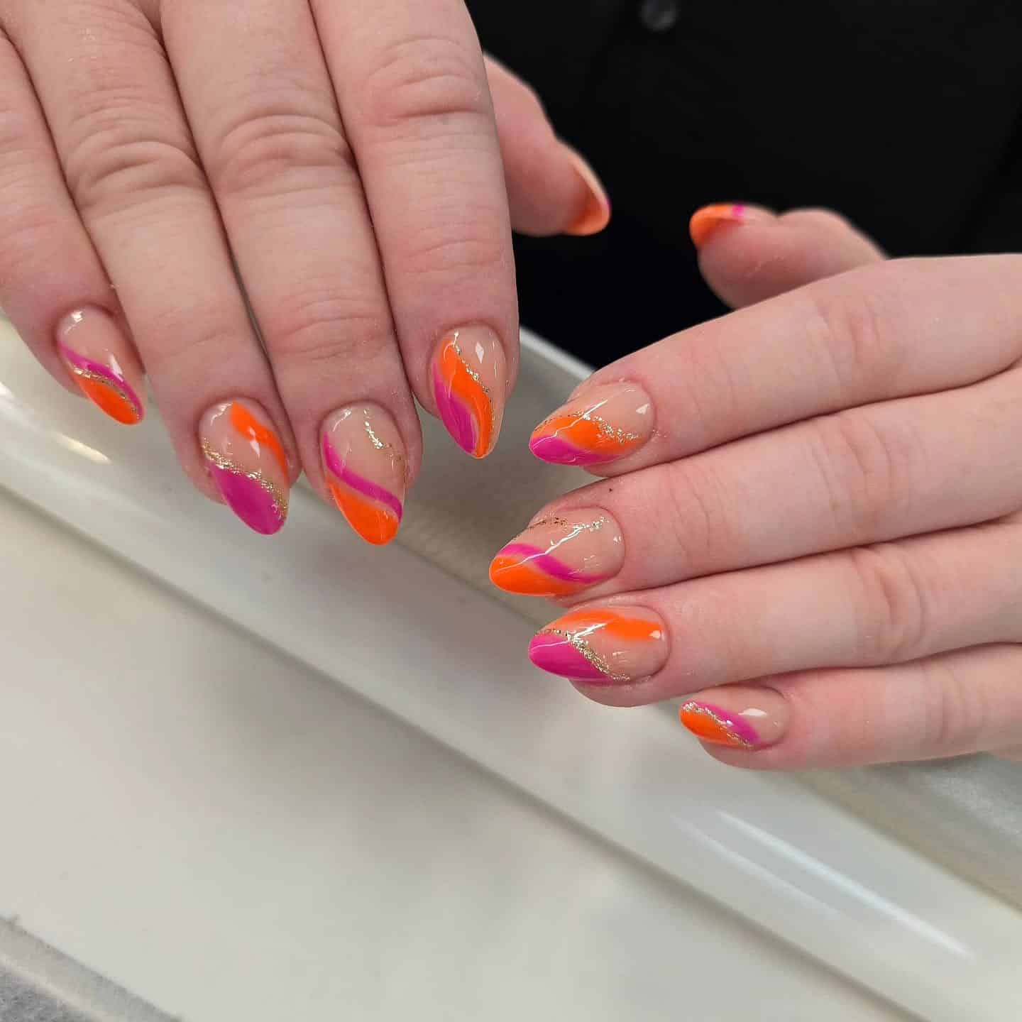 3. Sunset Swirl Almond Nails - pink and orange nail ideas