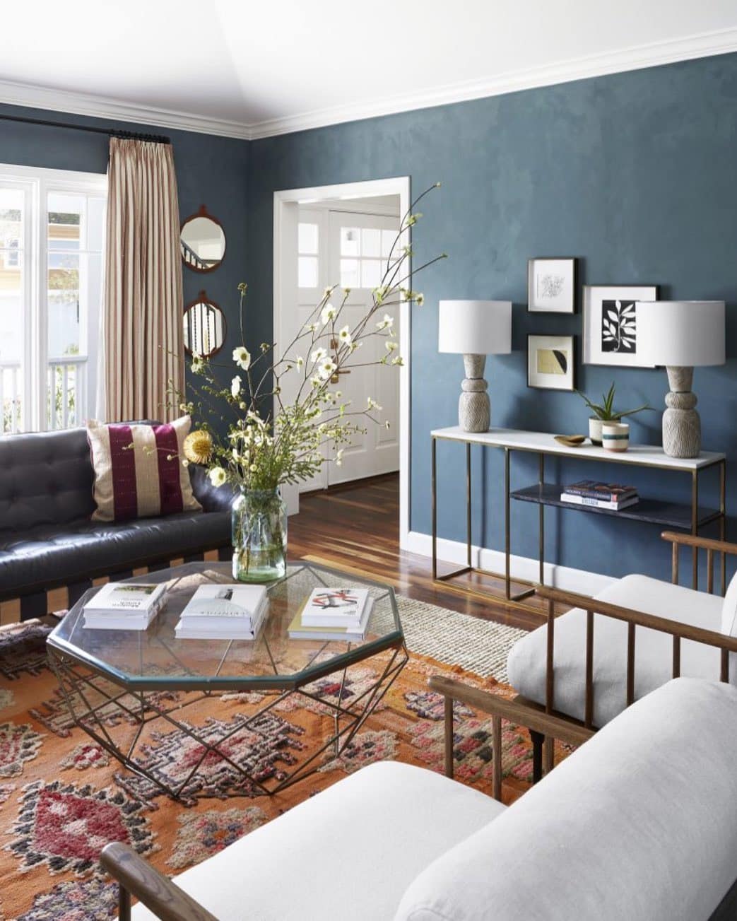 2. Modern Eclectic Warmth with Blue Walls - gray and blue living room ideas