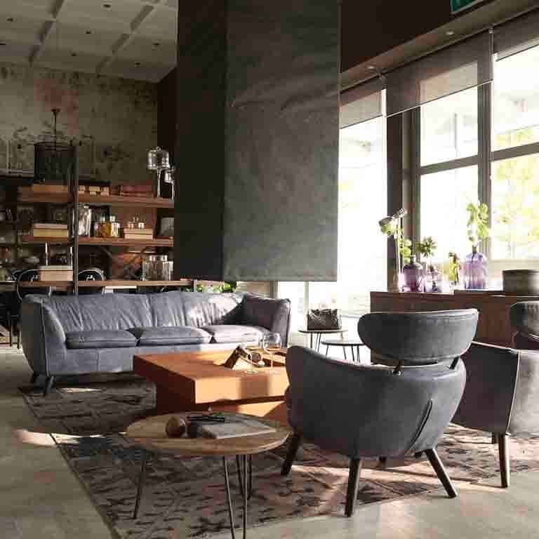 16. Contemporary Factory Lounge with Leather Accents - industrial living room ideas
