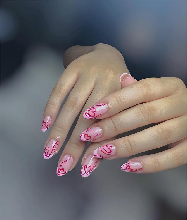 3. Glossy Pink Almond Nails with Red Heart Outlines - pink valentine nail ideas