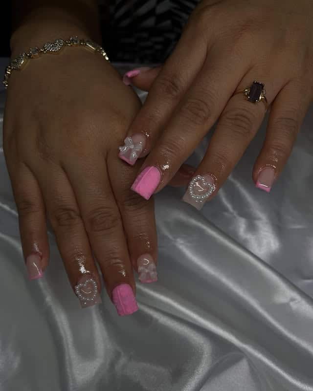 15. Glossy Pink Nails with Pearl Hearts and Bows - pink valentine nail ideas