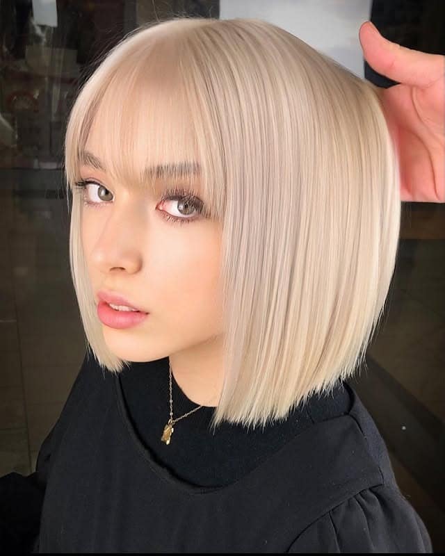 15. Cool Cream Platinum Bob with Bangs - Platinum Hair Color