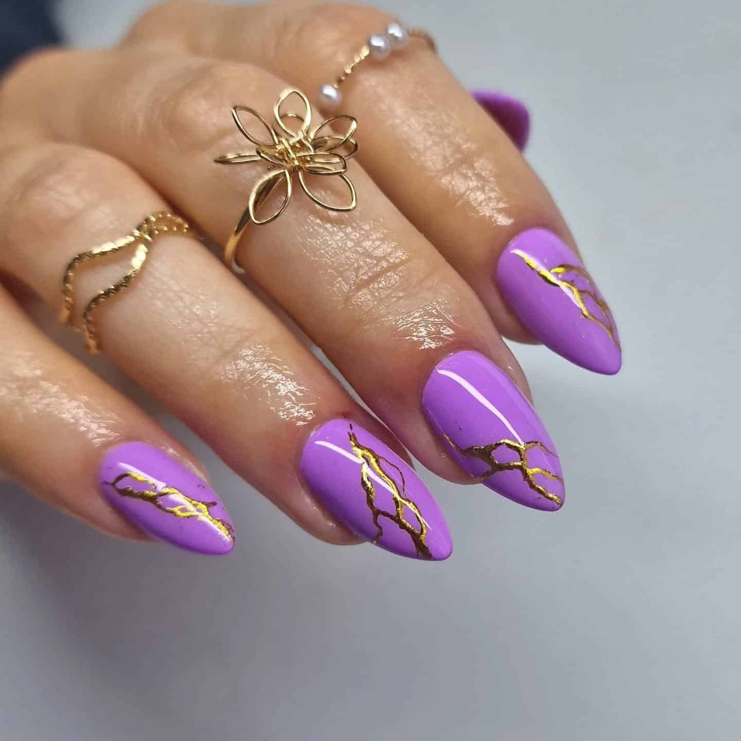 5. Violet Marble Veins - purple and gold nail ideas