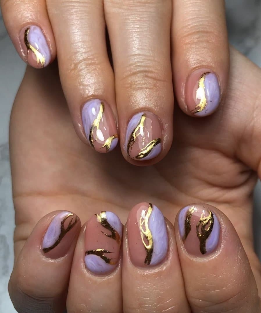10. Abstract Lilac Gold Swirls - purple and gold nail ideas