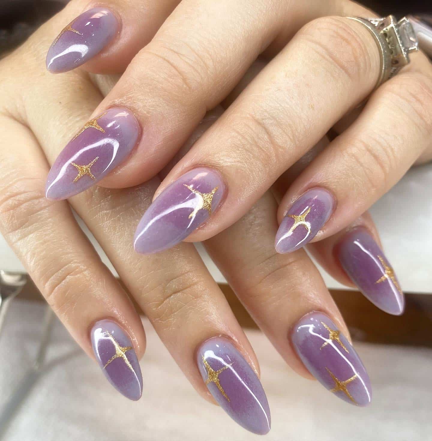 20. Golden Star Shimmer - purple and gold nail ideas
