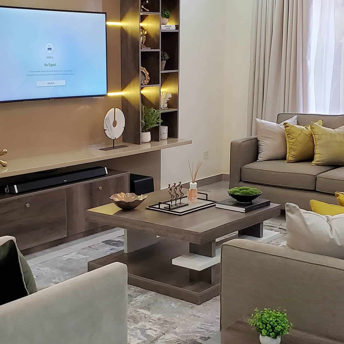 2. Modern Harmony in Taupe and Mustard - brown and gold living room ideas