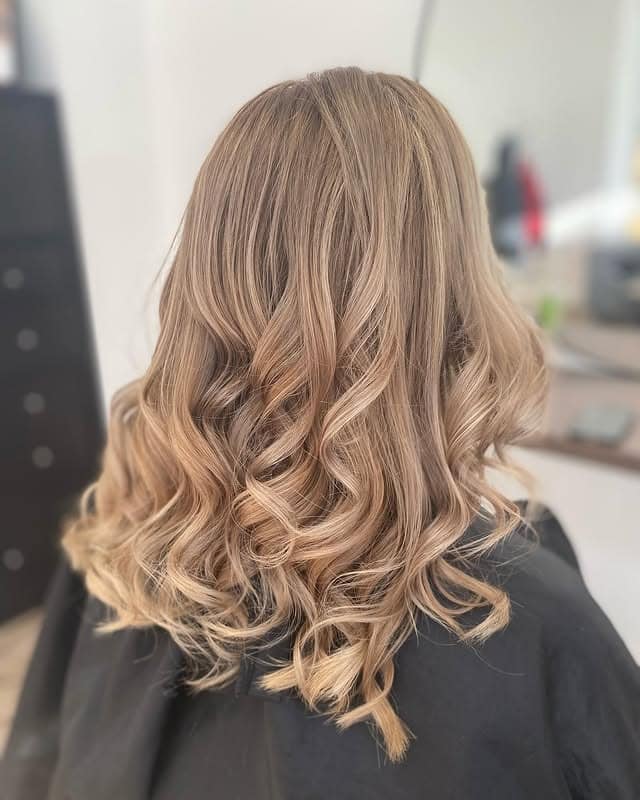 8. Dimensional Sand Blonde Curls - Dark Blonde Hair Color