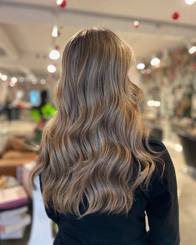 9. Glossy Mushroom Blonde Waves - Dark Blonde Hair Color