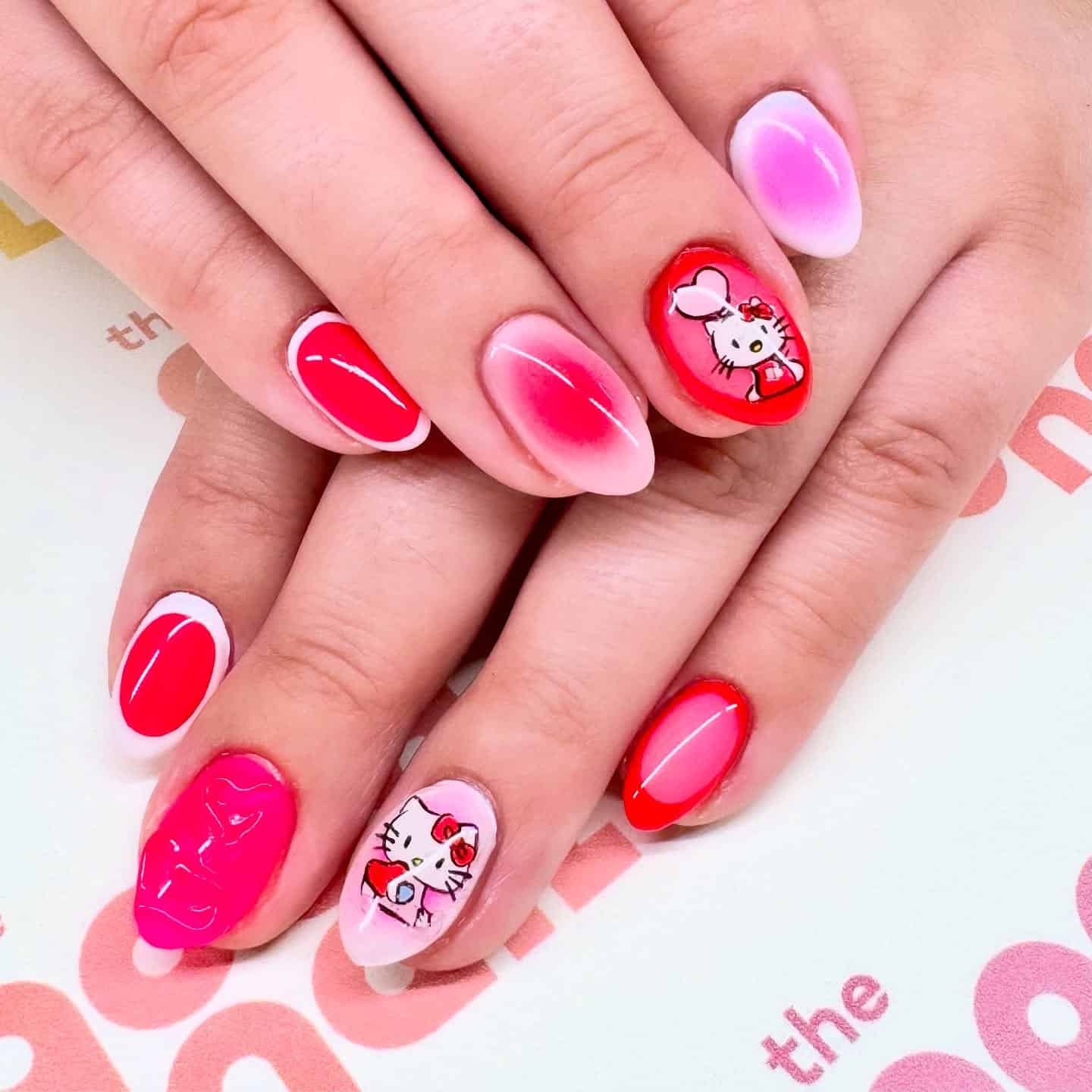 9. Hello Kitty Gradient Charm - red and pink nail ideas