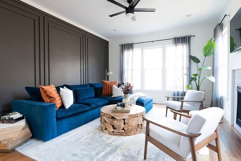 5. Bold Contrast with Deep Blue and Warm Neutrals - large living room wall ideas