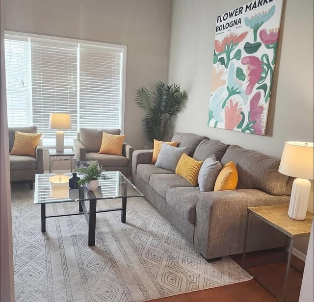 6. Contemporary Comfort with Pops of Yellow - large living room wall ideas