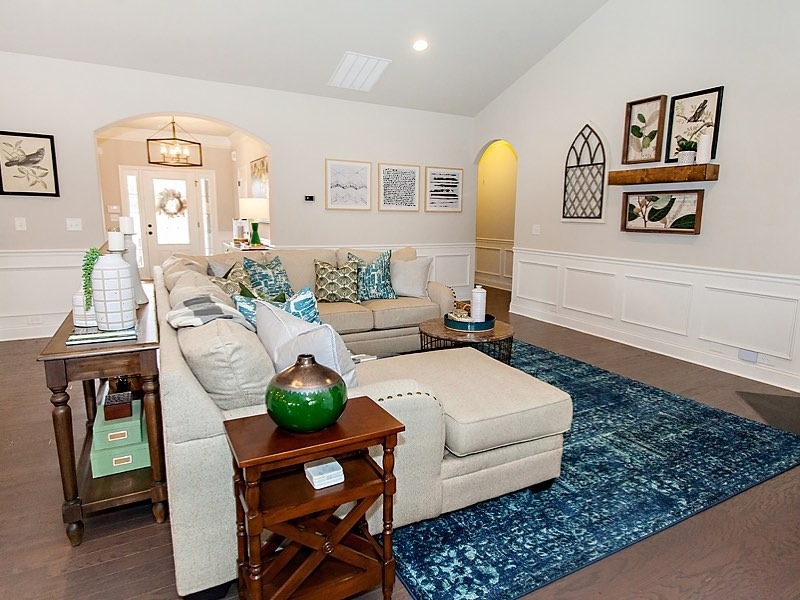 7. Transitional Harmony with Soft Blues and Natural Textures - large living room wall ideas