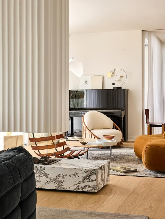 17. Mid-Century Influence with Marble and Curves - large living room wall ideas