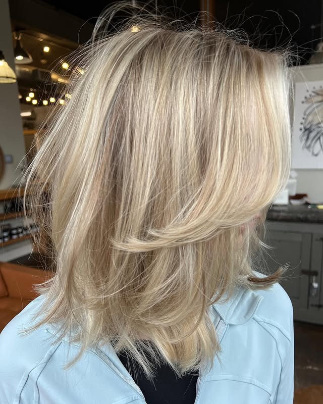 13. Feathered Blonde Layers with a Luminous Finish - Short Hair with Layers
