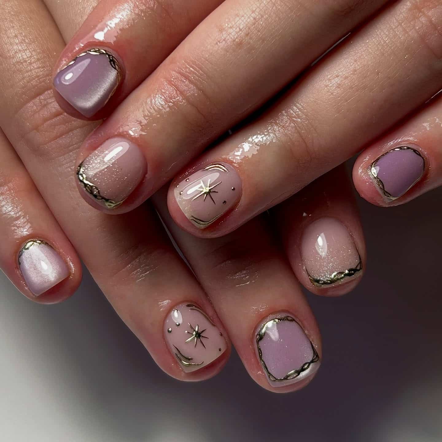 7. Lavender Gleam – Metallic and Star Accent Design - rounded nail ideas